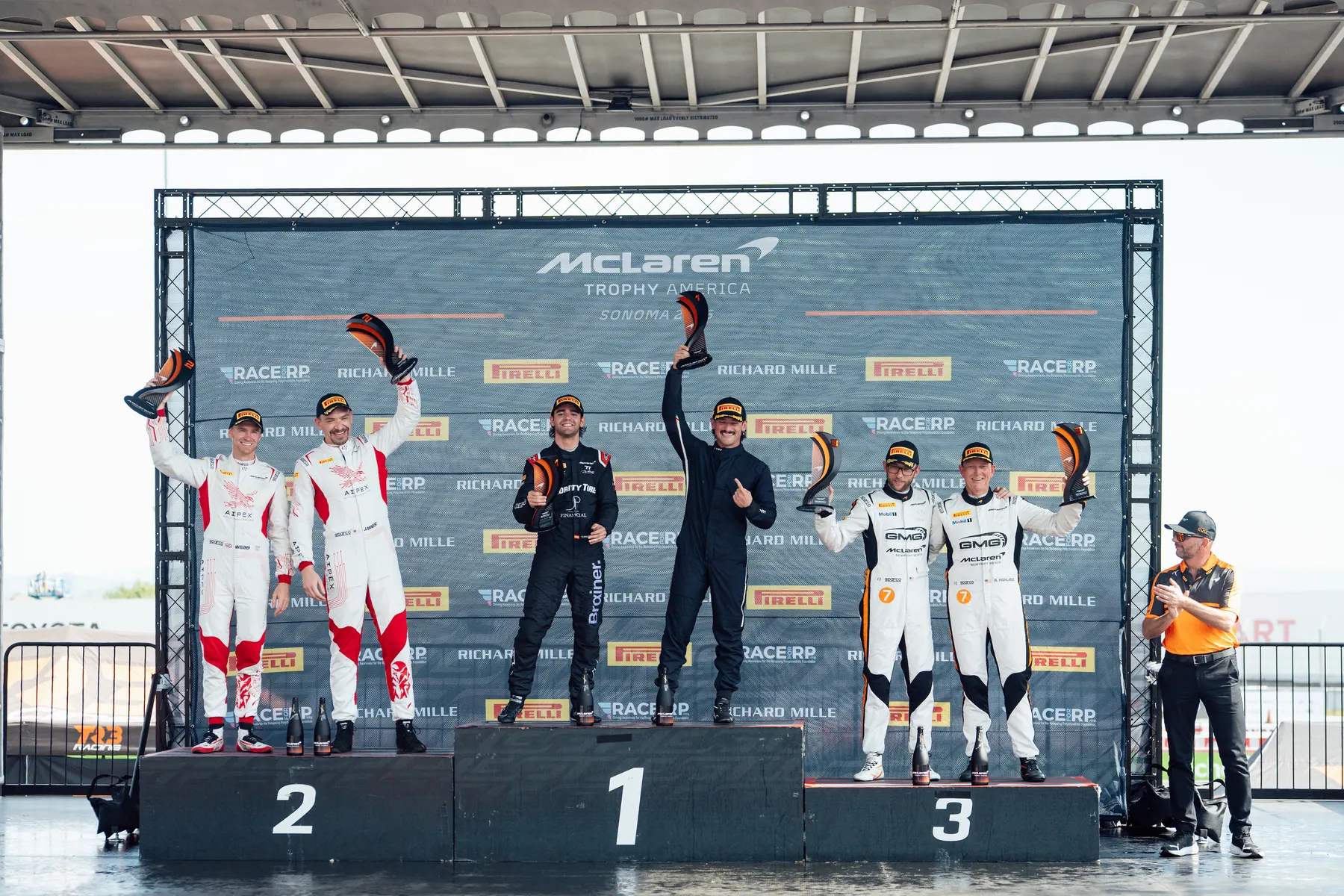 Drivers celebrating on the McLaren Trophy America podium