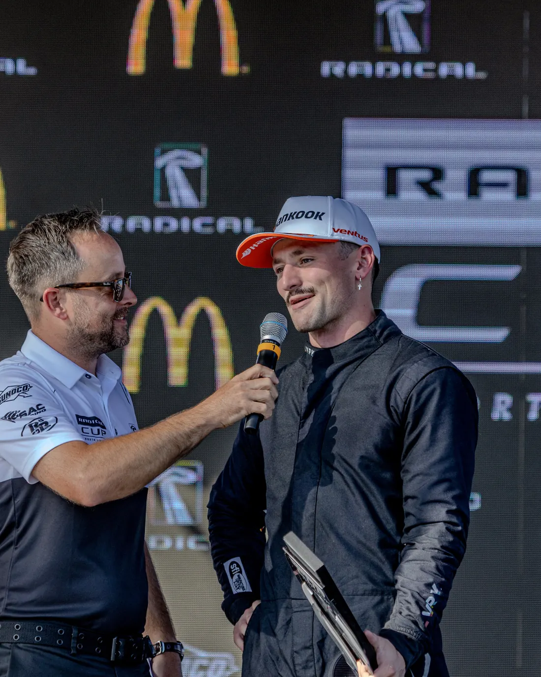 Spencer Schmidt being interviewed on the Radical Cup podium
